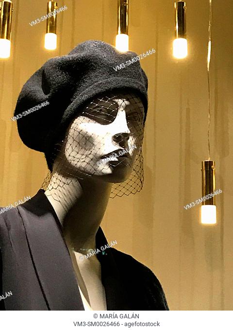 Mannequin wearing hat with veil in a shop window. Serrano street, Madrid, Spain