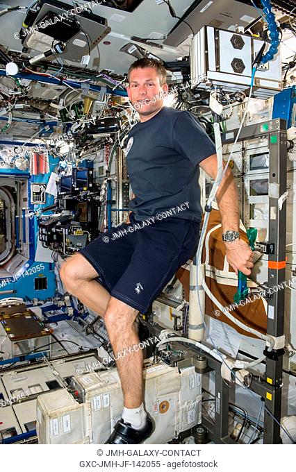DanishESA astronaut Andreas Mogensen is seen working out on a stationary bicycle inside the U.S. Destiny Laboratory. Mogensen lived and worked on the...