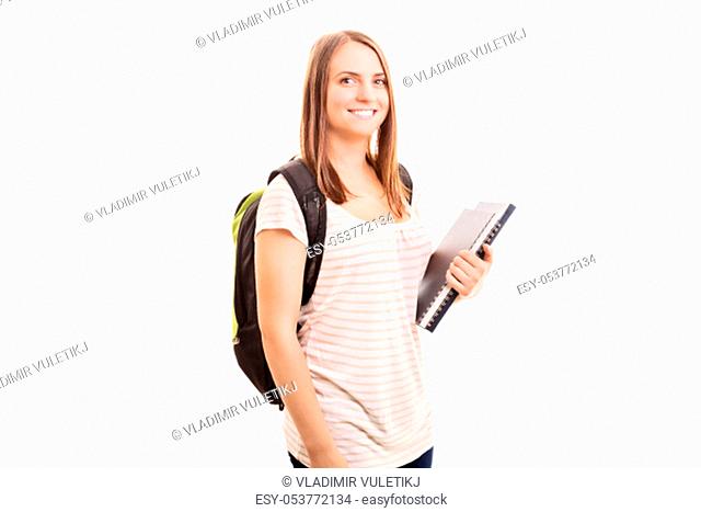 Back to school, finally! Young girl carrying a backpack, some books while going to school, isolated on white background