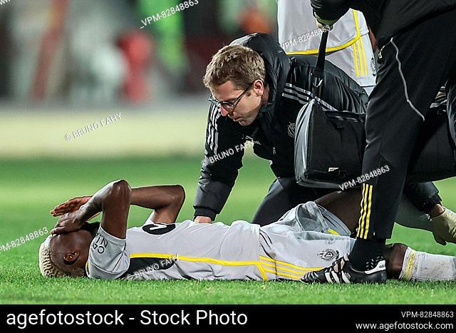 Standard's Moussa Djenepo lies injured on the ground during a soccer match between KV Mechelen and Standard de Liege Wednesday 20 December 2023 in Mechelen