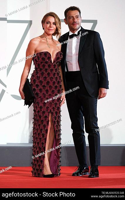 Claudia Gerini, Simon Clementi walks the red carpet ahead of the movie ""Filming Italy best movie award"" at the 77th Venice Film Festival on September 06