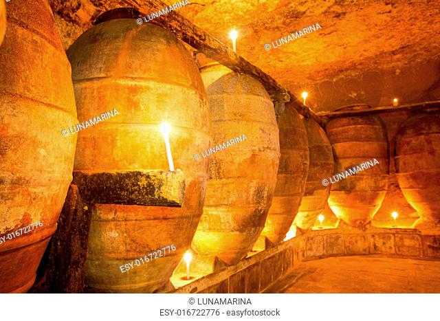 Antique winery in Spain with clay vessels terracotta amphora pots Mediterranean tradition with candlelight