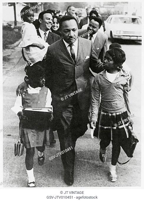 Martin Luther King Jr. Escorting Schoolchildren to Newly Integrated School, Andrew Young, Joan Baez and Hosea Williams in Background, Grenada, Mississippi, USA