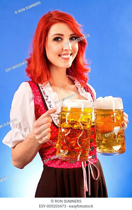 Beautiful woman serving beer at Oktoberfest