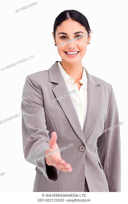 Smiling businesswoman offering her hand against a white background