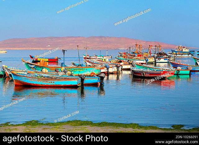 Colorful fishing boats anchored in Paracas Bay, Peru. Paracas is a small port town catering to tourists visiting Paracas Reserve and Ballestas islands