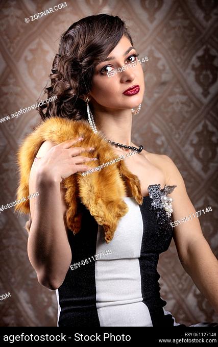 Retro woman portrait. Beautiful girl with red fur in the style of the 20s or 30s. Old fashionable Finger Wave makeup and hairstyle