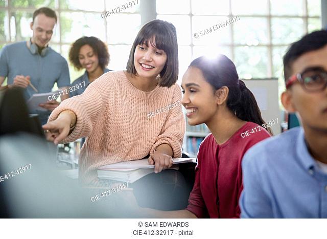 College students talking in classroom