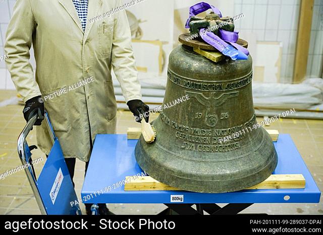 23 October 2020, Rhineland-Palatinate, Speyer: A so-called Hitler bell, the Essinger Glocke, is cleaned with a brush in the collection centre of the Historical...