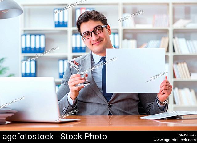 Businessman in office holding a blank message board