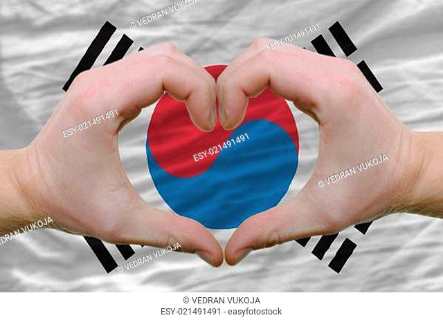 Heart and love gesture showed by hands over flag of south korea