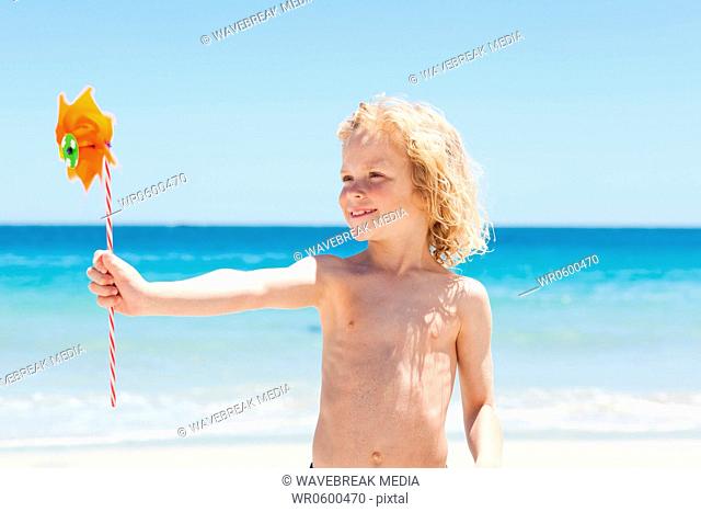 Boy on the beach with wind wheel