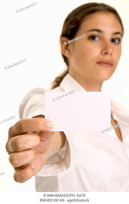 An attractive young woman holds up a blank business card