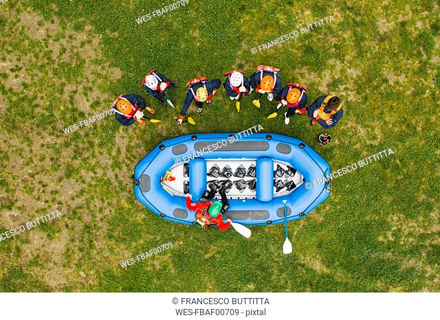 Top view of instructor talking to group of friends at a rafting class