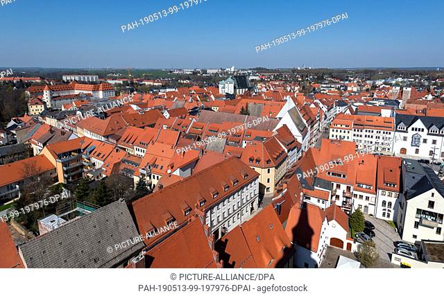 16 April 2019, Saxony, Freiberg: Panoramic view from the tower of the St. Petri church to the oldtown with the castle Freudenstein (l) and the cathedral St
