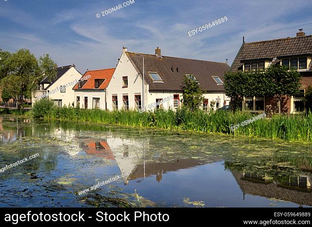 Houses on the river Graafstroom in the small hamlet Gijbeland in the Dutch region Alblasserwaard