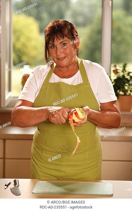 Woman peeling apple / potato peeler, knife
