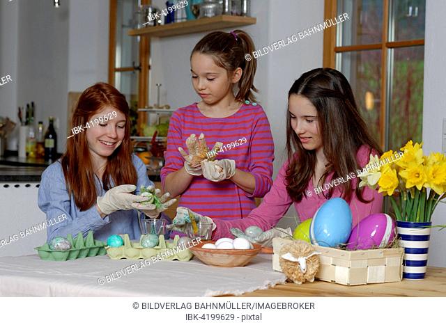 Girls colouring Easter eggs for Easter, Upper Bavaria, Bavaria, Germany