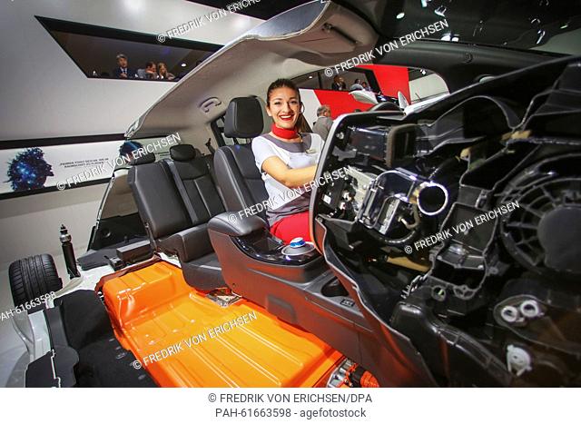 A hostess poses in a cutaway model of the Nissan Leaf electric car at the exhibition stand of Nissan at the International Motor Show IAA in Frankfurt/Main