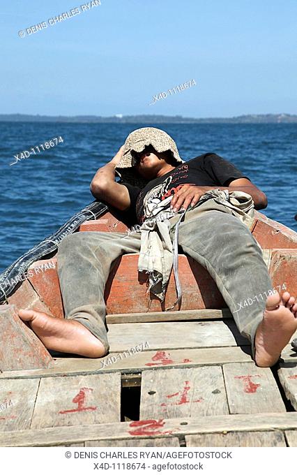 Man sleeping in boat, Cambodia