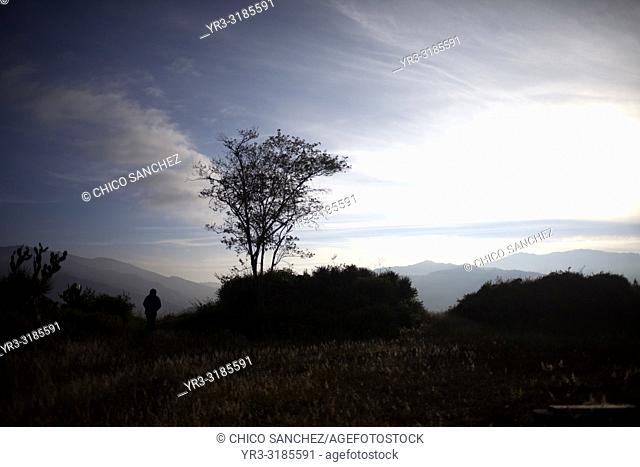 A woman walks at sunrise in Lachatao, in the Sierra Norte of Oaxaca, Mexico