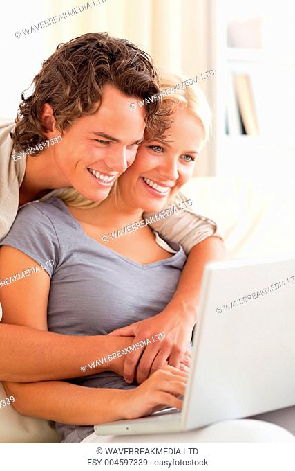Portrait of a young couple using a laptop