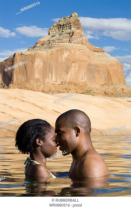 Profile of a young couple standing in a lake