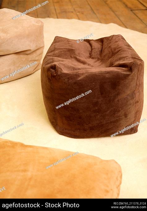 A detail of suede covered squashy floor cushions