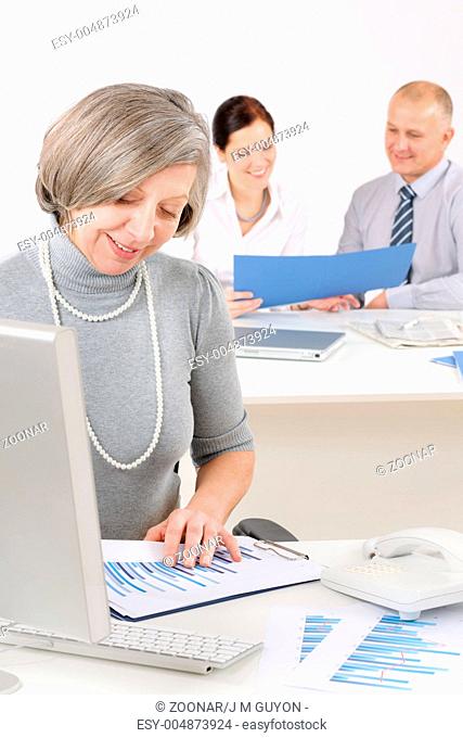 Senior executive woman look at charts