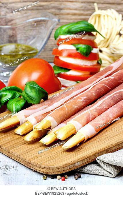 Traditional italian breadsticks in raw ham