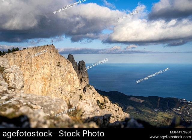 High rocks Ai-Petri of Crimean mountains. Black sea coast and blue sky with clouds in autumn. Russia