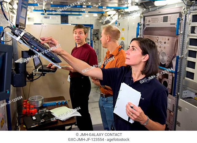Astronauts Nicole Stott, Expedition 2021 flight engineer; Tim Kopra (center) and Michael Barratt, both Expedition 1920 flight engineers