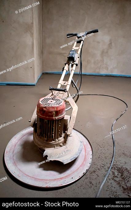 professional machine for performing and polishing sand and cement screed floor on the construction site of a new two-level apartment