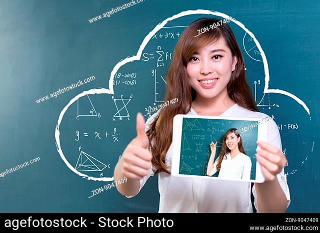 beautiful asian girl teacher with tablet and green blackboard