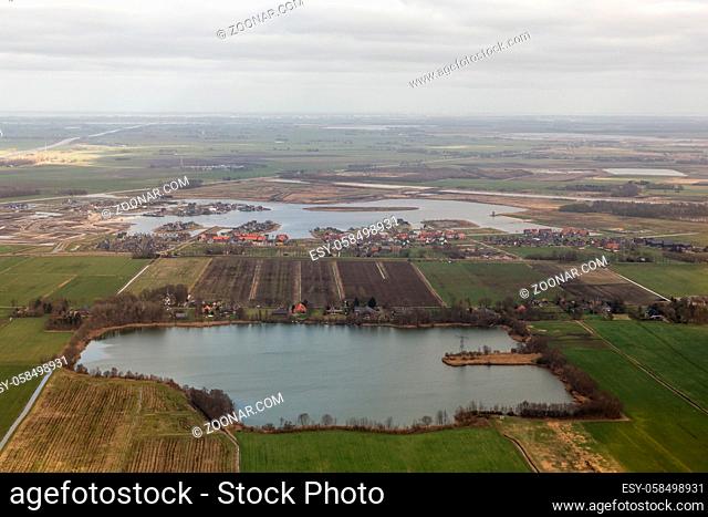 Aerial view lake with construction site new residential area Meerstad at Woldmeer near city Groningen, The Netherlands