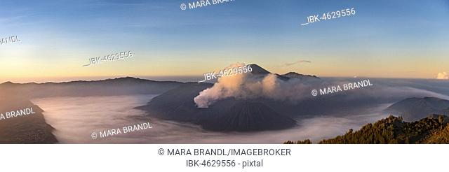 Caldera Tengger, view of volcanoes at sunrise, smoking volcano Gunung Bromo, with Mt. Batok, Mt. Kursi, Mt. Gunung Semeru, National Park Bromo-Tengger-Semeru