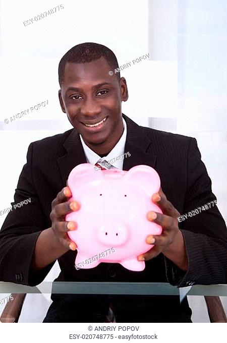 Businessman Holding Piggybank