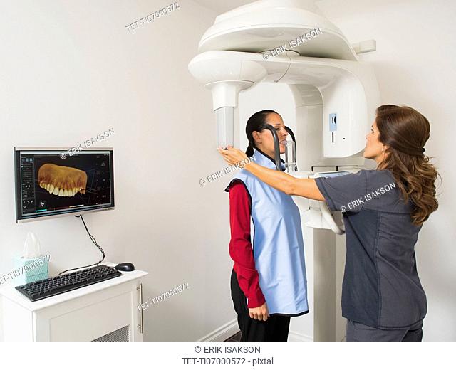Assistant making x-ray image of patient teeth
