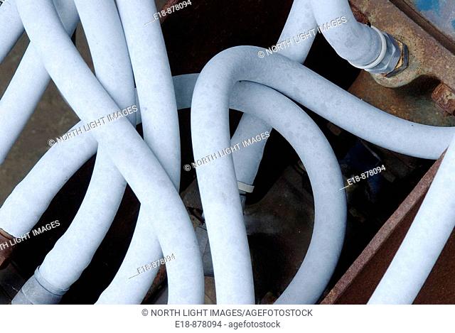 Canada, BC, Sicamous.  Confusion of hydraulic hoses on old saw mill equipment