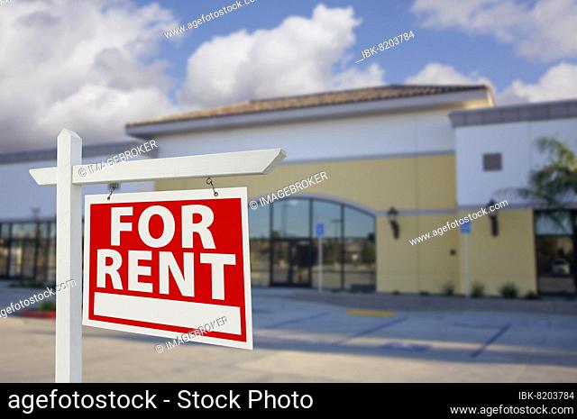 Vacant retail building with for rent real estate sign in front