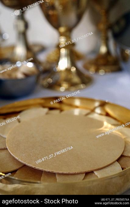Catholic mass. Eucharist table with the liturgical items. Communion wafers. France