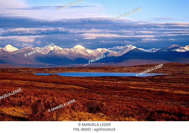 Lake with mountain range in background, Denali Highway, Alaska Range, Alaska, USA