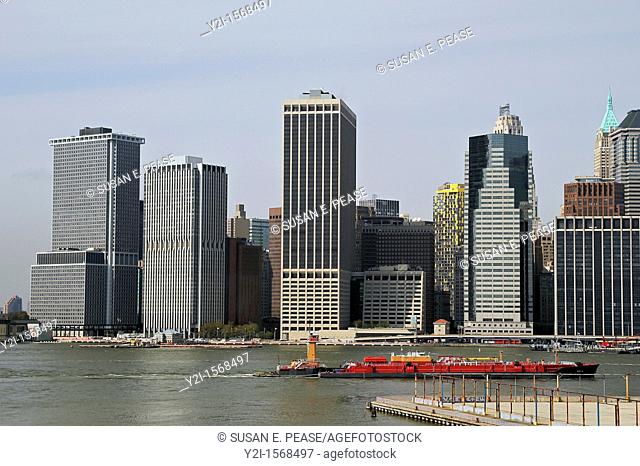 A view of Lower Manhattan from the Brooklyn Heights Promenade as a boat passes in the East River  New York City, New York, United States