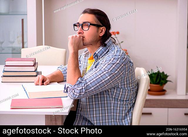 Male student preparing for exam at home