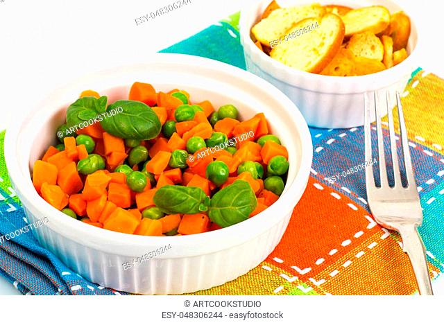 Carrots and green peas on a couple of Diet. Studio Photo