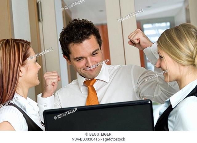 three young, successfully business people using laptop
