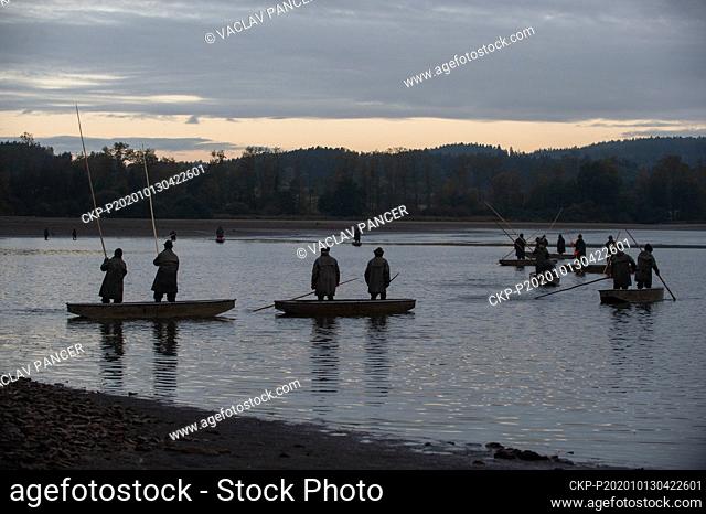 Fishermen fish out the Velkorojicky pond near Rojice, Strakonice region, Czech Republic, on October 13, 2020. (CTK Photo/Vaclav Pancer)