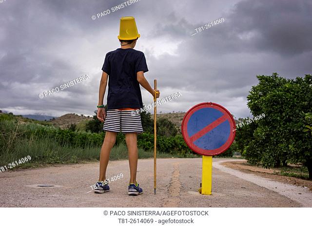 Child with bucket on his head, Bugarra, Spain