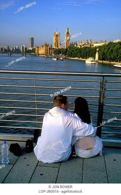 England, London, South Bank, Couple on Millennium Bridge in the early morning