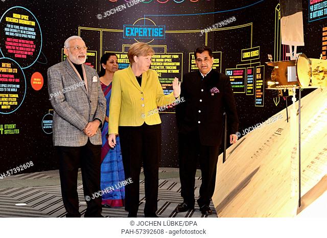 German Chancellor Angela Merkel (C), Indian Prime Minister Narendra Modi (L) and Indian state secretary Amitabh Kant (R) visit the stand of India during their...